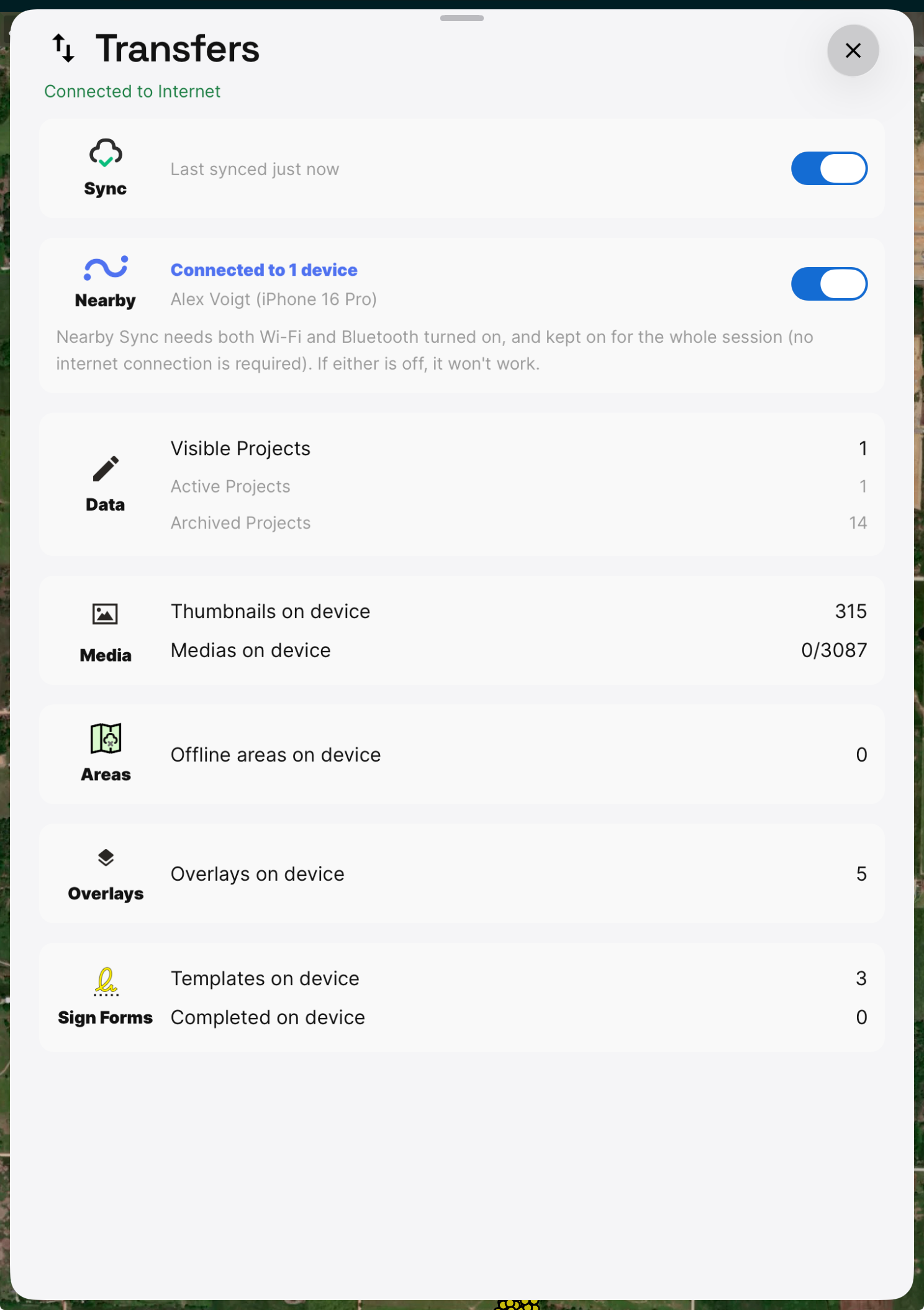 The Transfers sheet with Sync at the top and a Nearby row reading Connected to 1 device, naming the connected device, above counts for Data, Media, Areas, Overlays, and Sign Forms